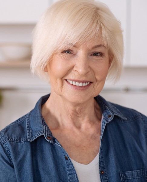 Senior woman in a denim jacket smiling