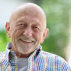 Close-up of senior man in colorful shirt smiling