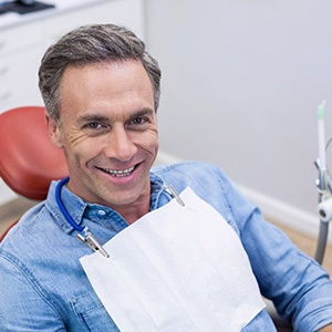 A smiling middle-aged man sitting in a dentist’s chair