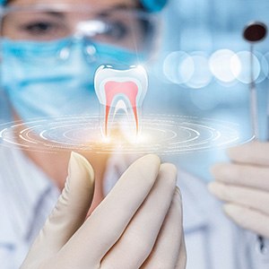 Dentist with blue mask and white gloves holding up dental instruments next to an illustration of a levitating tooth