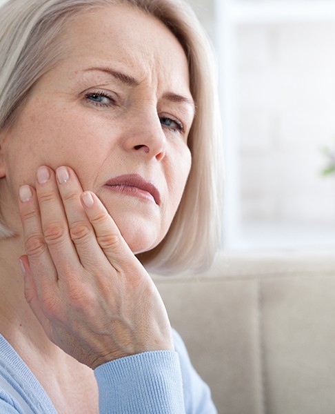 Older woman suffering from mouth pain