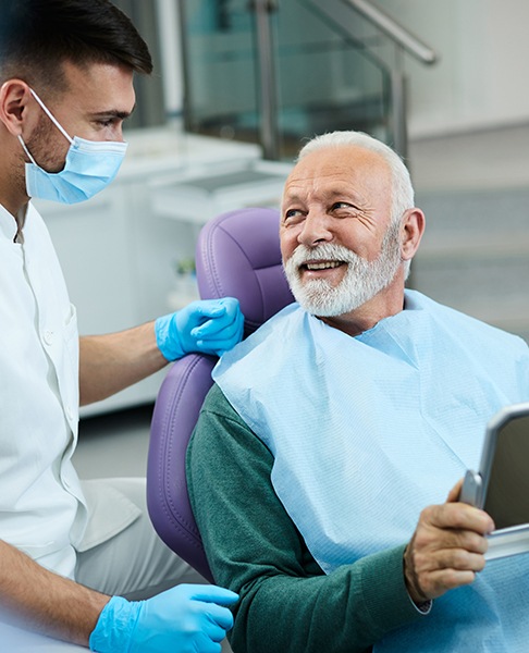 Smiling dental patient interacting with his dentist