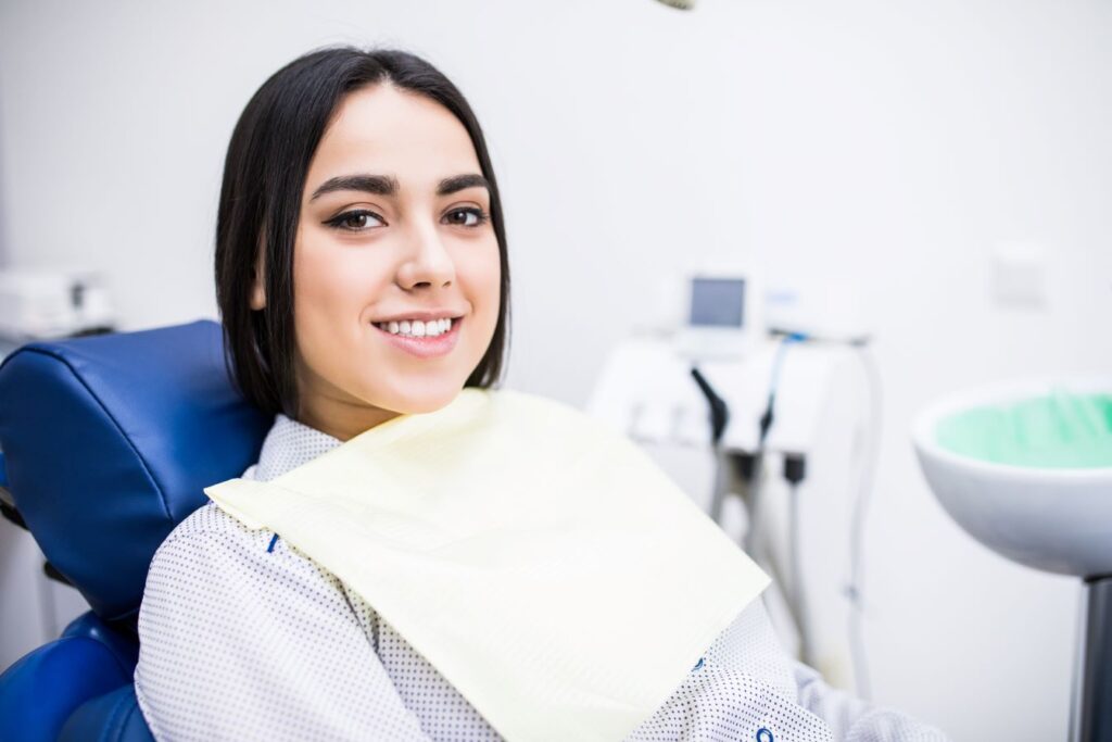 A woman sitting in a dental chair.