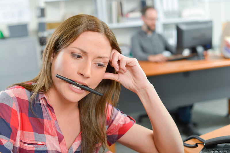 Patient biting a pen after getting dental implants